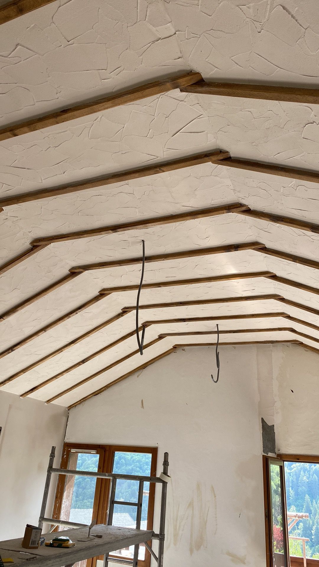 Traditional textured lime plaster on a vaulted timber-beamed ceiling, by SJM Plastering